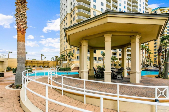 surrounding community with a gazebo and a swimming pool