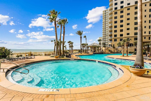 view of pool featuring a gazebo, a patio, and a water view