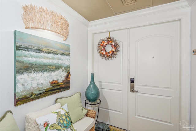 foyer entrance featuring crown molding