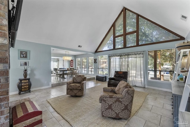 tiled living room featuring high vaulted ceiling and a notable chandelier