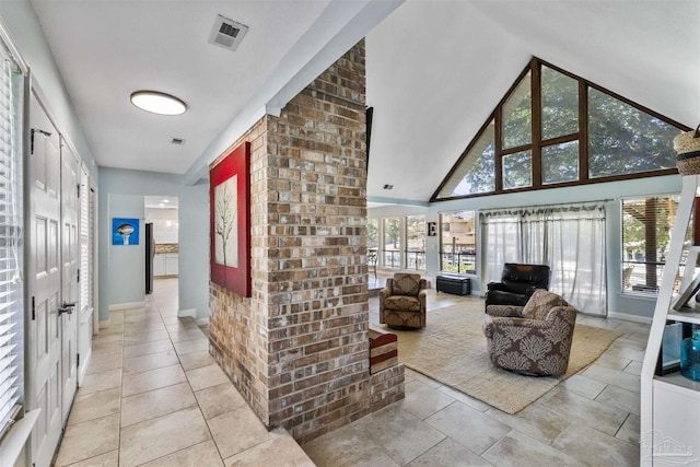 interior space featuring a healthy amount of sunlight and a high ceiling