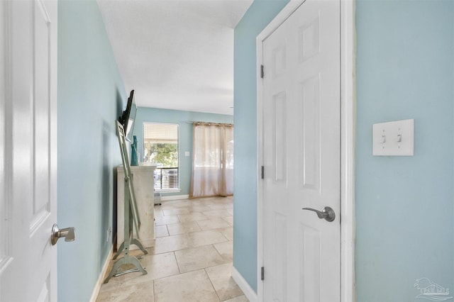 corridor featuring light tile patterned floors