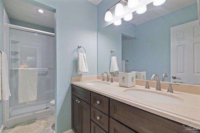 bathroom featuring tile patterned flooring, vanity, toilet, and walk in shower