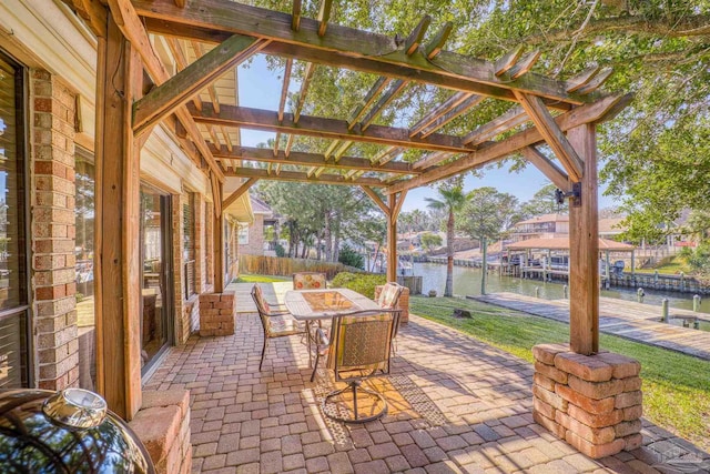 view of patio with a pergola and a water view