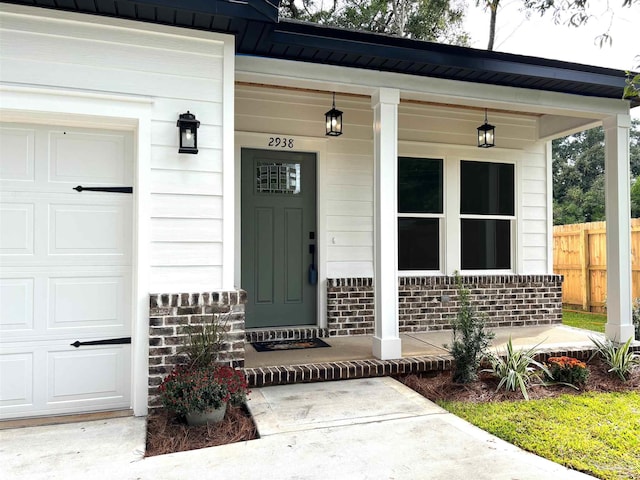 property entrance featuring a garage and a porch