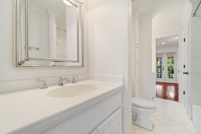 3869 Paradise Bay Dr, Gulf Breeze, FL 32563 - full bathroom featuring toilet, vanity, tile patterned floors, french doors, and ornamental molding