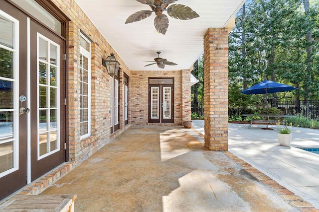 3869 Paradise Bay Dr, Gulf Breeze, FL 32563 - property entrance with ceiling fan, french doors, a patio, and brick siding