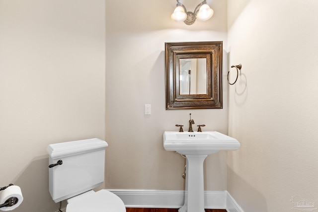 3869 Paradise Bay Dr, Gulf Breeze, FL 32563 - half bathroom featuring toilet and a chandelier