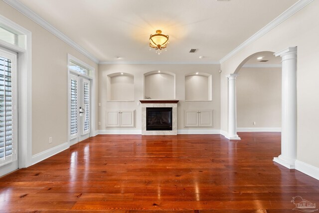 3869 Paradise Bay Dr, Gulf Breeze, FL 32563 - unfurnished living room with ornate columns, wood finished floors, a fireplace, ornamental molding, and baseboards