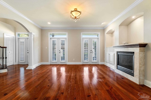 3869 Paradise Bay Dr, Gulf Breeze, FL 32563 - unfurnished living room featuring a tile fireplace, wood finished floors, ornate columns, crown molding, and baseboards
