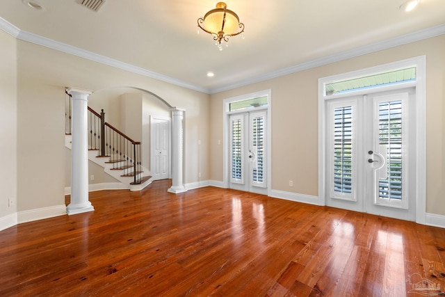3869 Paradise Bay Dr, Gulf Breeze, FL 32563 - foyer entrance with ornate columns, french doors, hardwood / wood-style flooring, ornamental molding, and arched walkways