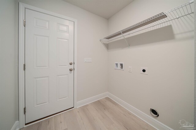 washroom featuring hookup for a washing machine, light hardwood / wood-style floors, and hookup for an electric dryer