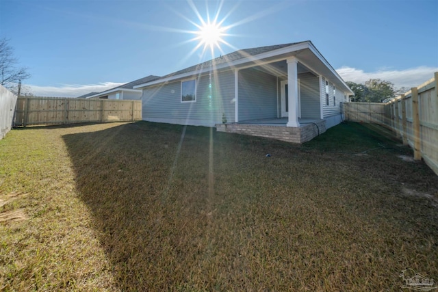 view of property exterior with a yard and a patio area