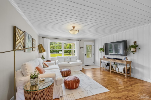 living room with wood ceiling, baseboards, ornamental molding, and light wood-style flooring