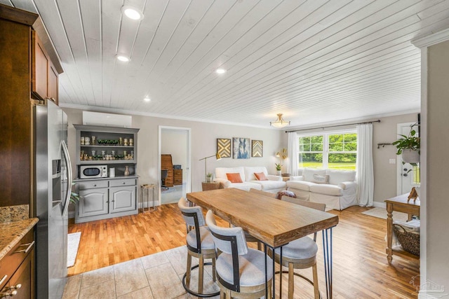 dining area with light wood-style floors, wooden ceiling, ornamental molding, and recessed lighting