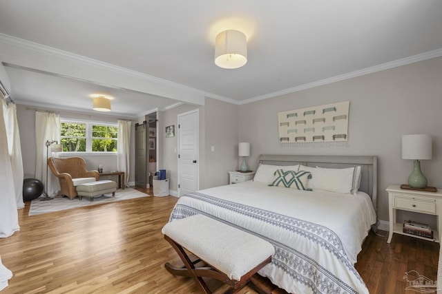 bedroom featuring baseboards, ornamental molding, and wood finished floors