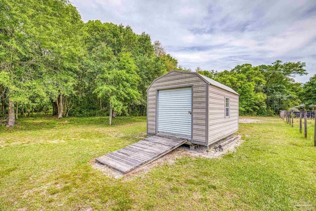 view of shed featuring fence