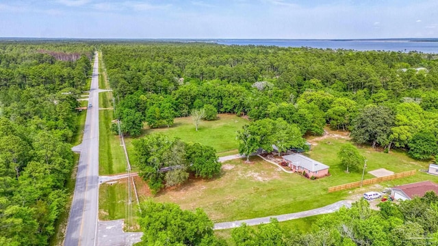 aerial view with a water view and a wooded view