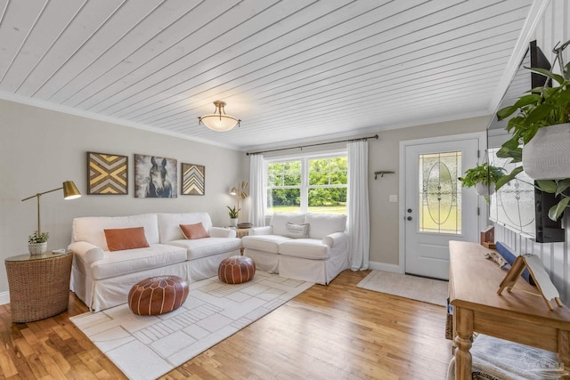 living room with crown molding, baseboards, wood ceiling, and light wood-style floors