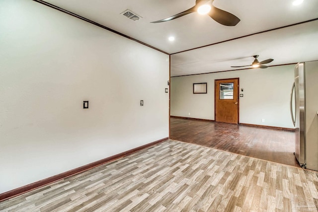 unfurnished room featuring light wood-type flooring, baseboards, ceiling fan, and visible vents