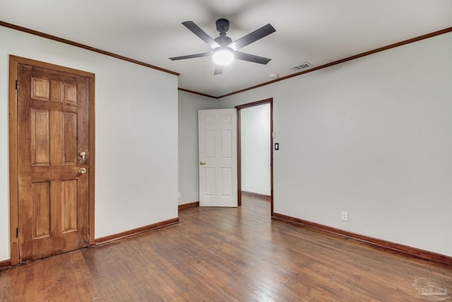 unfurnished bedroom featuring baseboards, visible vents, ornamental molding, and wood finished floors