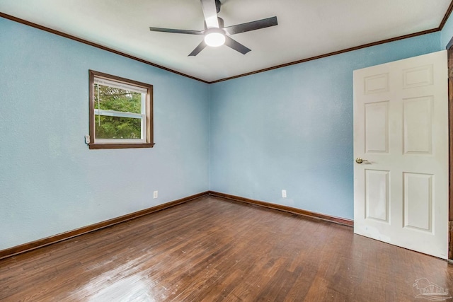 spare room featuring baseboards, ornamental molding, a ceiling fan, and wood finished floors