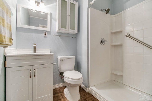 full bath with vanity, toilet, wood finished floors, and a shower