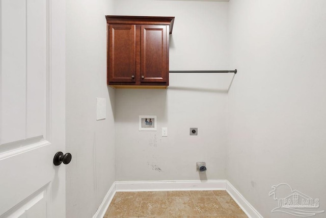 washroom featuring hookup for a washing machine, cabinet space, baseboards, and hookup for an electric dryer