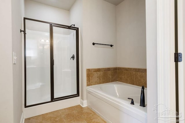 bathroom featuring a stall shower, a garden tub, and tile patterned floors