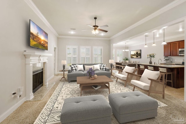 living area featuring plenty of natural light, a fireplace, baseboards, and crown molding