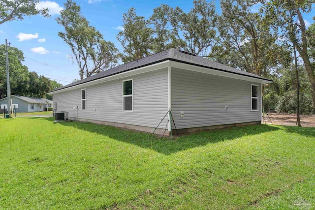 view of property exterior featuring central AC unit and a yard