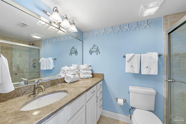 full bathroom featuring toilet, a stall shower, visible vents, and vanity