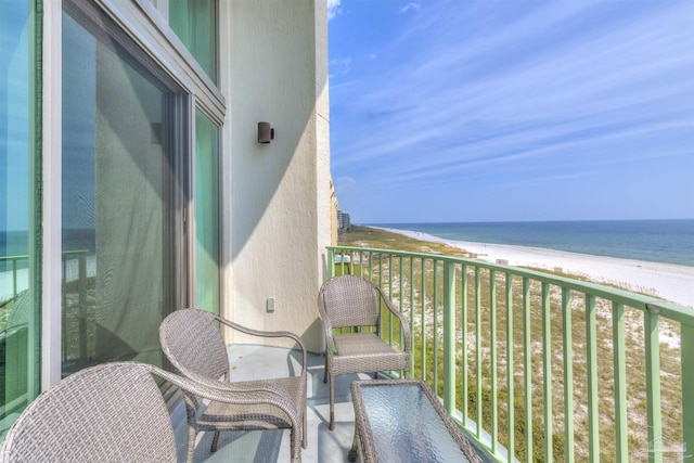 balcony with a beach view and a water view