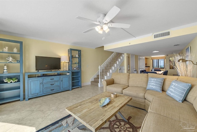 living area featuring light tile patterned floors, visible vents, stairway, and crown molding