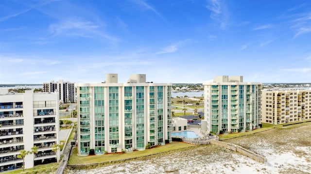 view of property featuring a water view and a city view