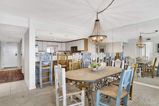 dining space featuring a chandelier and light carpet