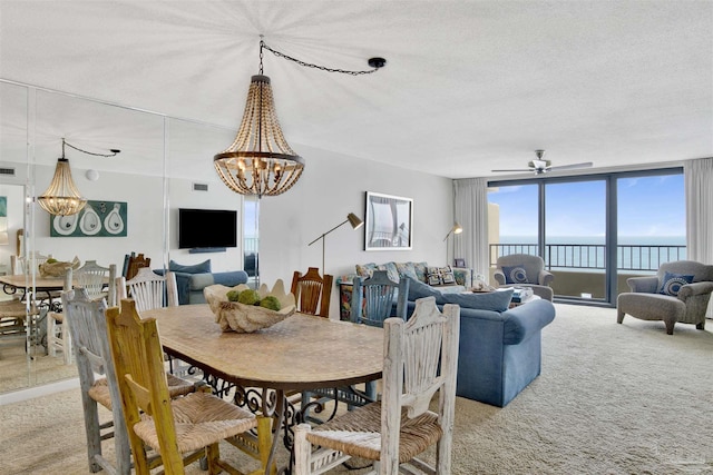 dining area featuring expansive windows, ceiling fan with notable chandelier, light carpet, and a textured ceiling