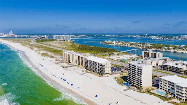 birds eye view of property featuring a water view and a beach view