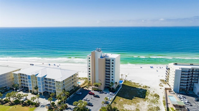 drone / aerial view with a beach view and a water view