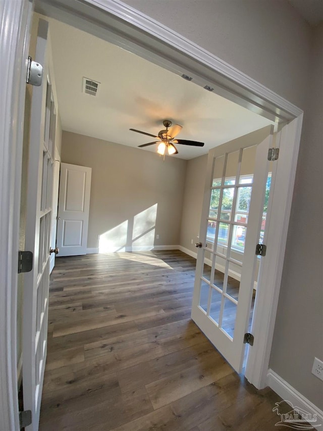 interior space featuring ceiling fan and dark wood-type flooring