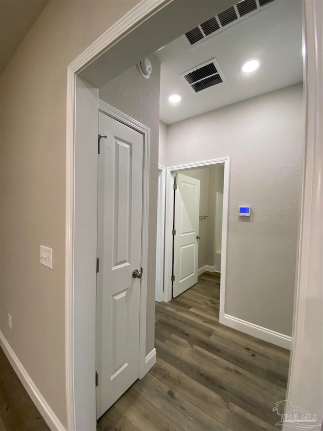 corridor featuring dark hardwood / wood-style flooring