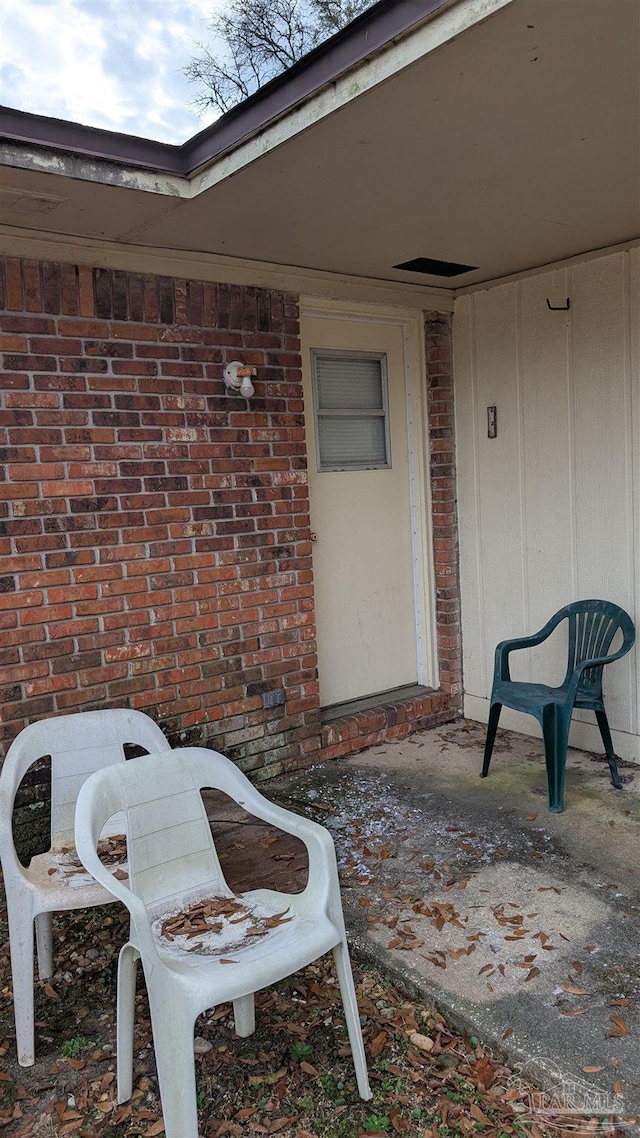 property entrance with brick siding