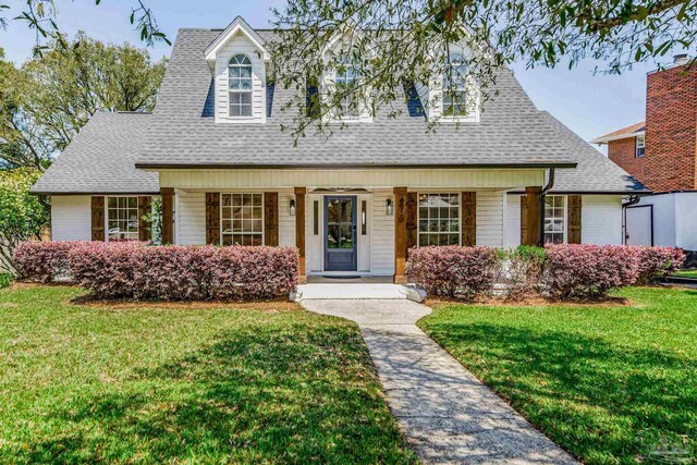 cape cod home with a front yard