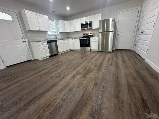 10 Middleton Ln, Atmore, AL 36502 - kitchen featuring white cabinets, baseboards, a sink, dark wood-style floors, and stainless steel appliances