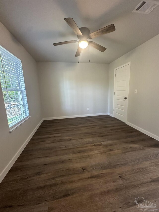 10 Middleton Ln, Atmore, AL 36502 - spare room featuring dark wood-style flooring, visible vents, ceiling fan, and baseboards