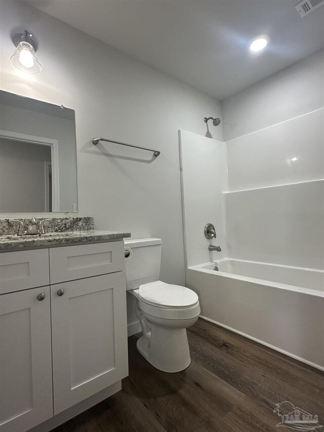 10 Middleton Ln, Atmore, AL 36502 - bathroom with visible vents, toilet, vanity, wood finished floors, and shower / bathtub combination