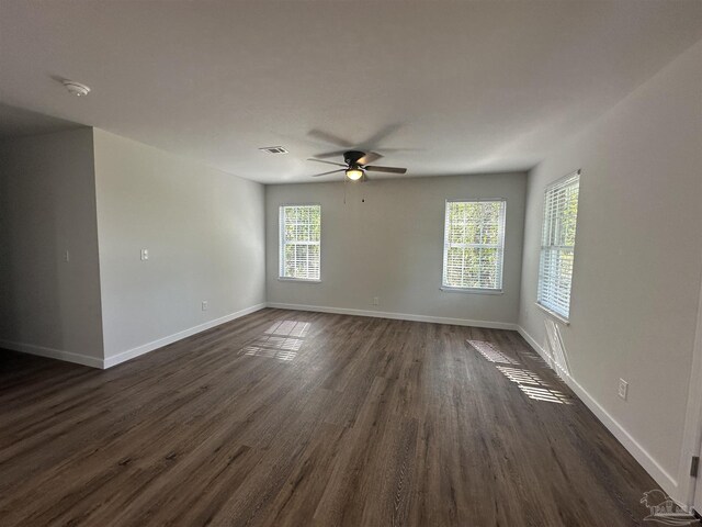 10 Middleton Ln, Atmore, AL 36502 - unfurnished room featuring visible vents, baseboards, a ceiling fan, and dark wood-style floors