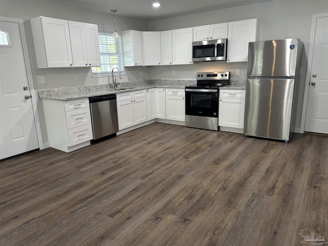 10 Middleton Ln, Atmore, AL 36502 - kitchen featuring a sink, appliances with stainless steel finishes, white cabinetry, dark wood-type flooring, and light stone counters