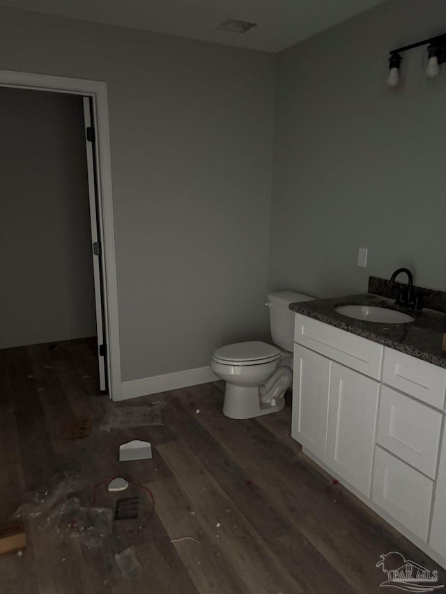 7147 Heath Rd, Milton, FL 32570 - bathroom with toilet, wood finished floors, and vanity