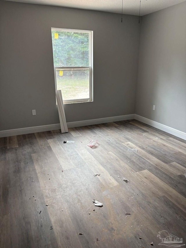 7147 Heath Rd, Milton, FL 32570 - spare room with wood finished floors and baseboards